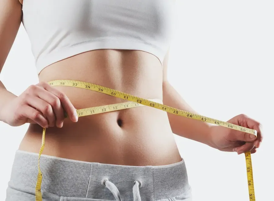 A measuring tape around a woman's waist